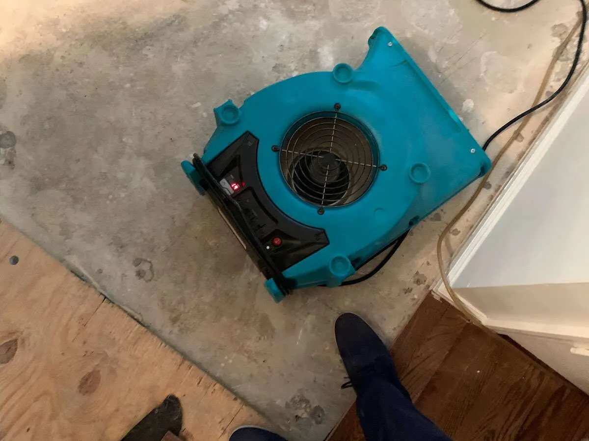 Air mover drying subfloor during Leak Detection & Repair in Rolla